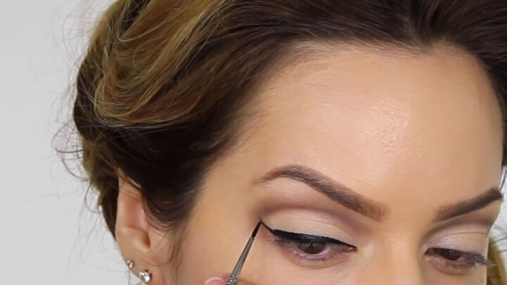 try this fun scary belle from beauty and the beast halloween makeup, Lining eyes and drawing a wing