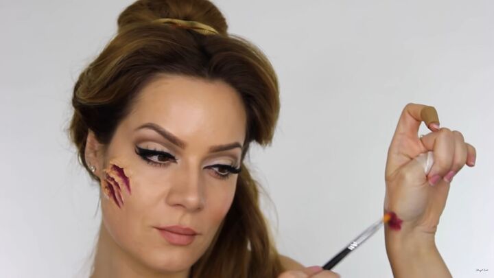 try this fun scary belle from beauty and the beast halloween makeup, Patting the color away on the hand