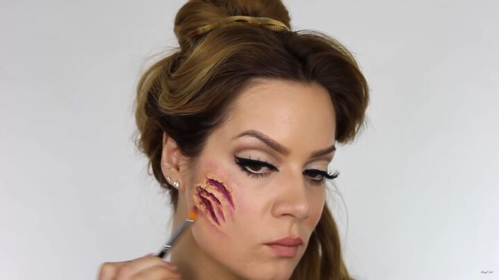 try this fun scary belle from beauty and the beast halloween makeup, Adding color around the wound to look sore