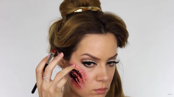 try this fun scary belle from beauty and the beast halloween makeup, Applying TV blood to the scary Belle makeup