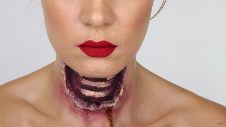 this gory ariel little mermaid makeup look is perfect for halloween, Creating bruising around the wound