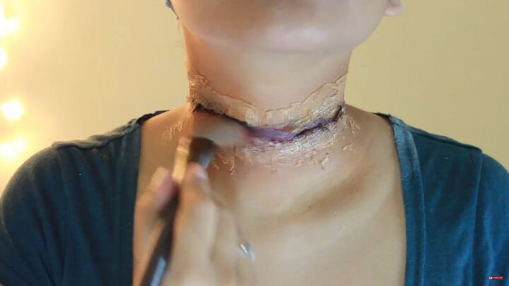 how to do scary slit throat makeup for halloween using kitchen items, Applying lipstick and lip gloss
