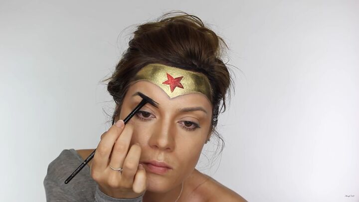 how to do effective comic book wonder woman makeup for halloween, Filling in eyebrows with a dark color