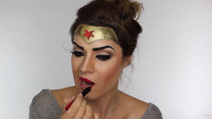 how to do effective comic book wonder woman makeup for halloween, Applying red lipstick