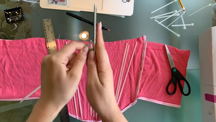 how to make a pretty diy corset tank top with old tees zip ties, Filing down the sharp edges of the zip ties