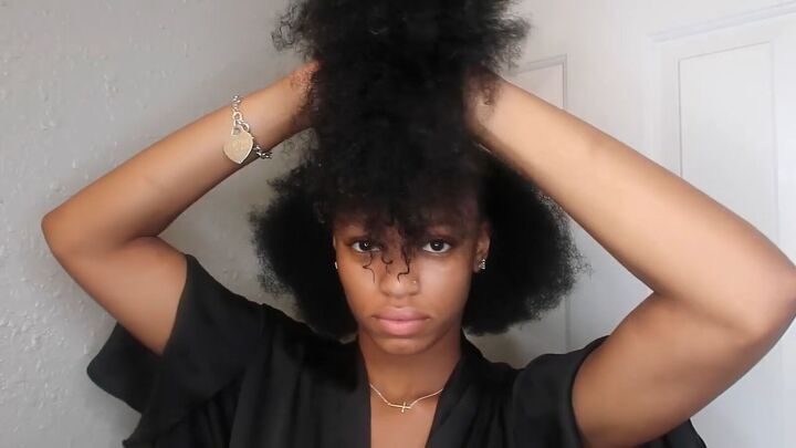 how to easily do a sleek top knot bun on natural hair, Tying the top section of hair out of the way