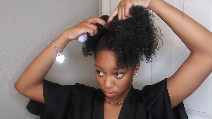 how to easily do a sleek top knot bun on natural hair, Brushing hair to detangle it