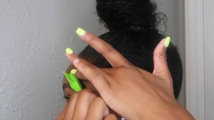 how to easily do a sleek top knot bun on natural hair, Cleaning up the edges with a brush