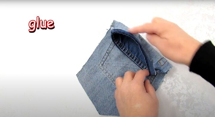 how to make a jean pocket purse with cute fringe detailing, Gluing the fold to hem the bag