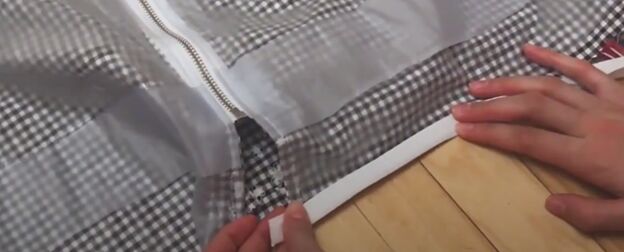 how to make a cute custom raincoat from an old coat gingham fabric, Hemming the raw edges