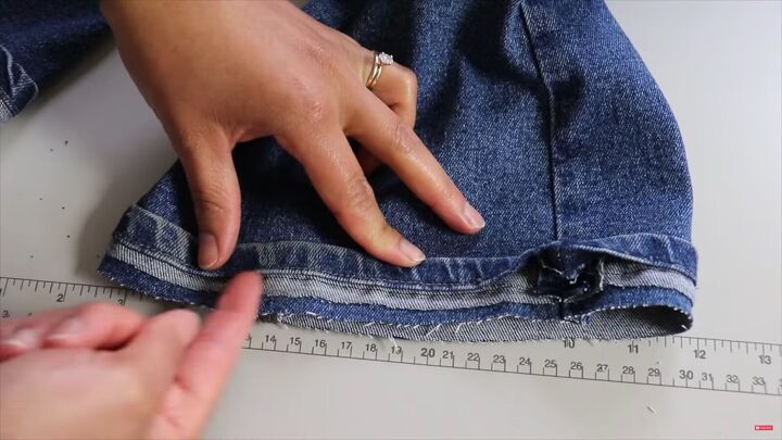 jeans too long here s how to hem flared jeans keep the original hem, Pushing the fabric into the seam to sew up