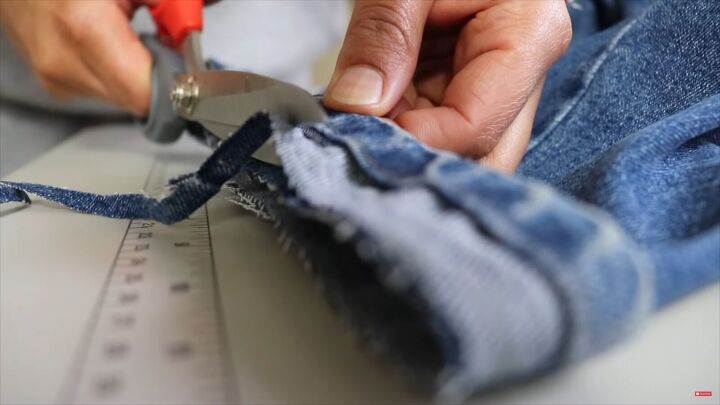 jeans too long here s how to hem flared jeans keep the original hem, Trimming the excess fabric at the bottom