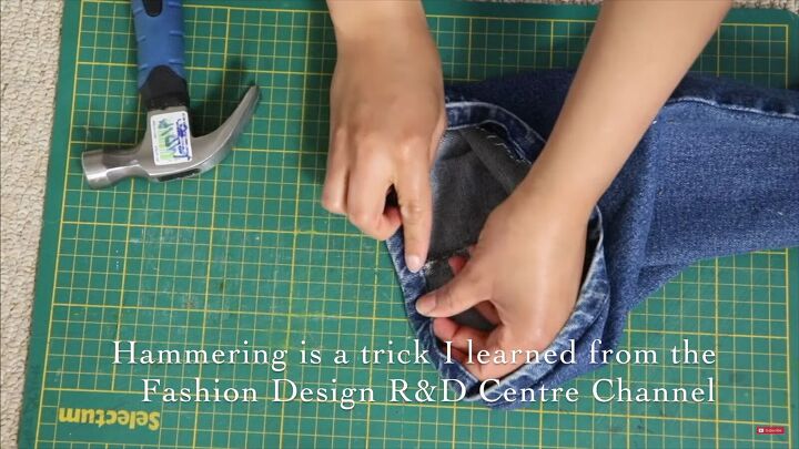 jeans too long here s how to hem flared jeans keep the original hem, Using a hammer to soften the denim fibers