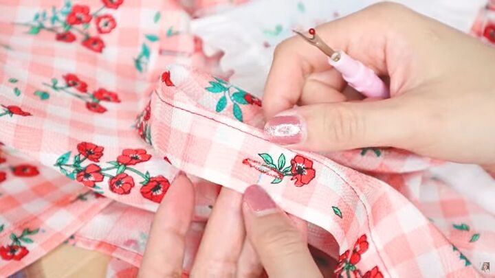 how to make a diy statement collar blouse with beautiful embroidery, Using a seam ripper to open the buttonholes