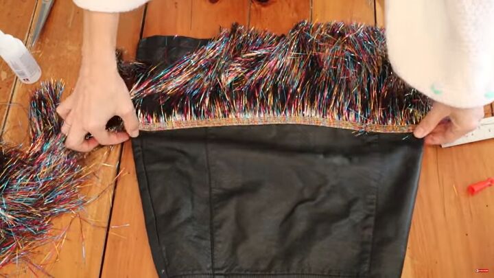 need a unique holiday outfit make this festive diy tinsel skirt, Stretching the skirt while gluing the tinsel