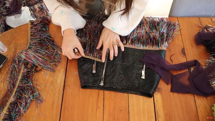 need a unique holiday outfit make this festive diy tinsel skirt, Gluing a second layer of tinsel to the skirt