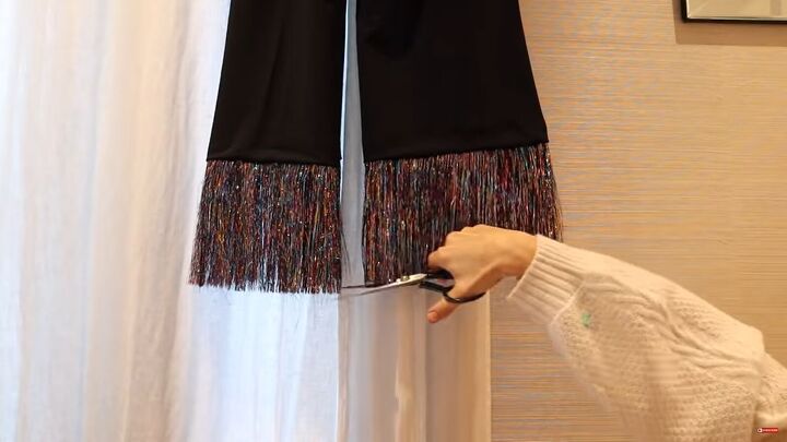 need a unique holiday outfit make this festive diy tinsel skirt, Trimming the ends of the tinsel trim