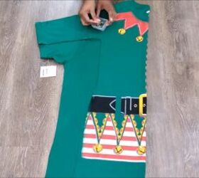 how to make an easy diy elf costume using a novelty christmas t shirt, Folding and cutting the fabric for symmetry