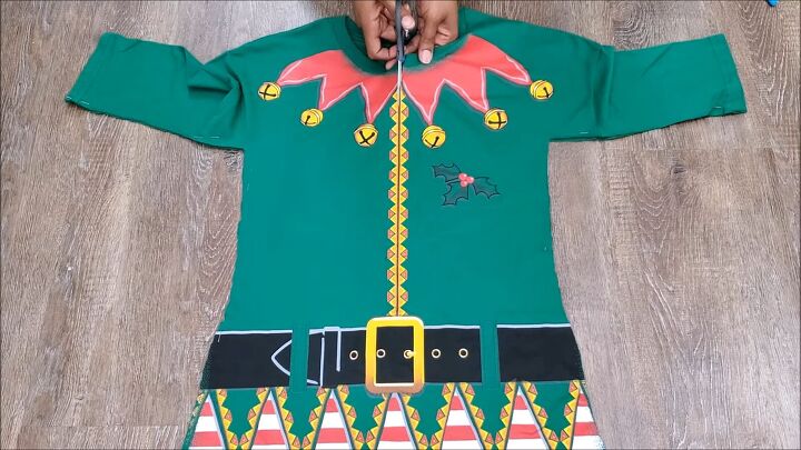 how to make an easy diy elf costume using a novelty christmas t shirt, Cutting down the center of the t shirt