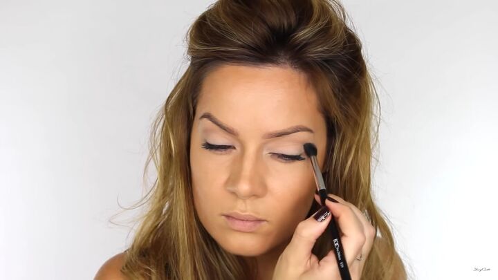 looking to wow this festive season try a sexy glitter eyeliner look, Applying taupe eyeshadow to the socket