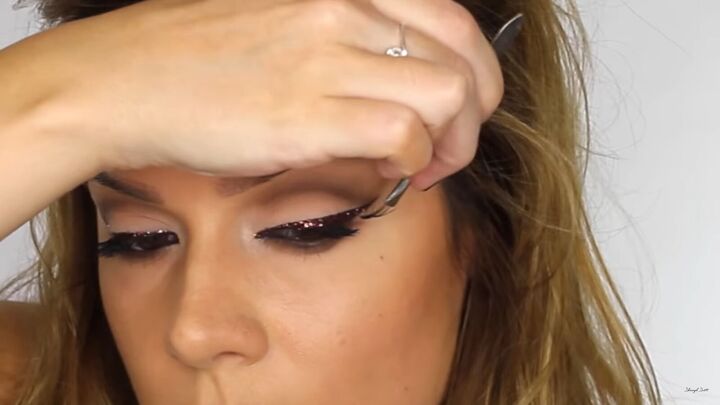 looking to wow this festive season try a sexy glitter eyeliner look, Applying false lashes on top glitter eyeliner