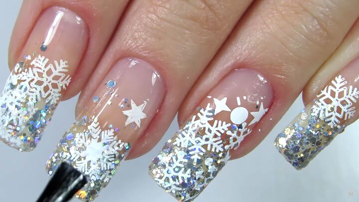 how to rock magical glitter snowflake nails this festive season, Applying a clear top coat over the nails