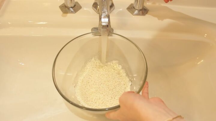 yao women rice water recipe how to make use it the authentic way, Rinsing the rice under a tap