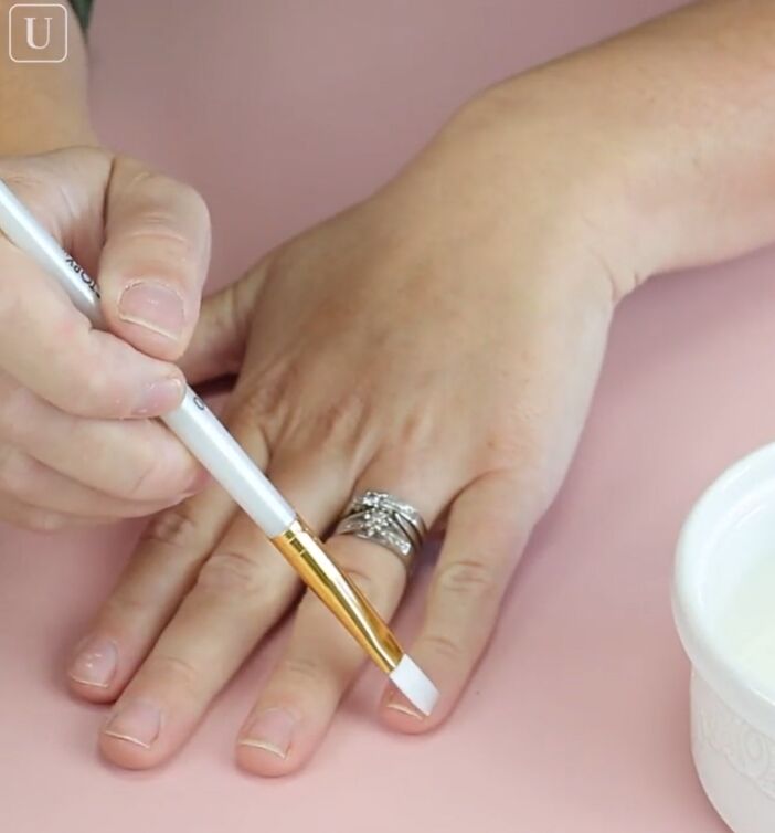 try these easy home manicure hacks to keep nails healthy shiny, Applying DIY cuticle oil with a paintbrush