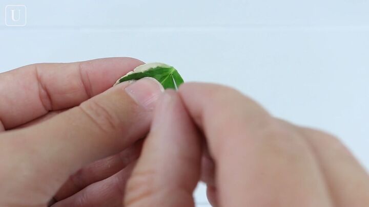 2 easy ways to make cute resin leaf earrings at home, Pushing a needle through the leaf