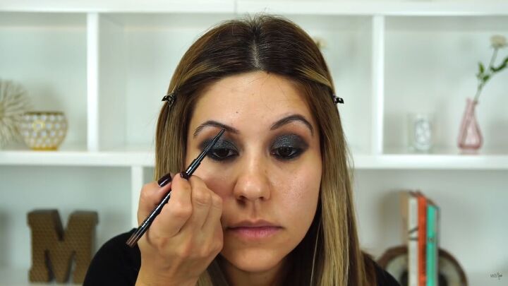 this sexy black glitter makeup look is perfect for holiday parties, Filling in brows with short feathery strokes