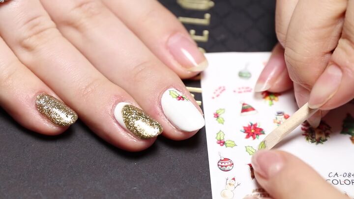 easy red white gold christmas nail art with festive stickers, Using Christmas nail design stickers