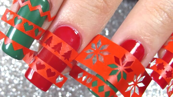 these festive green red christmas sweater nails are so easy to do, Applying Christmas nail vinyls
