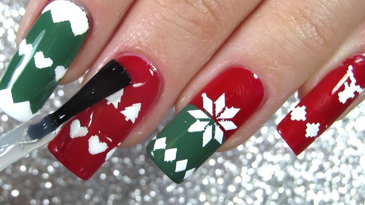 these festive green red christmas sweater nails are so easy to do, Applying a top coat on the Christmas nails