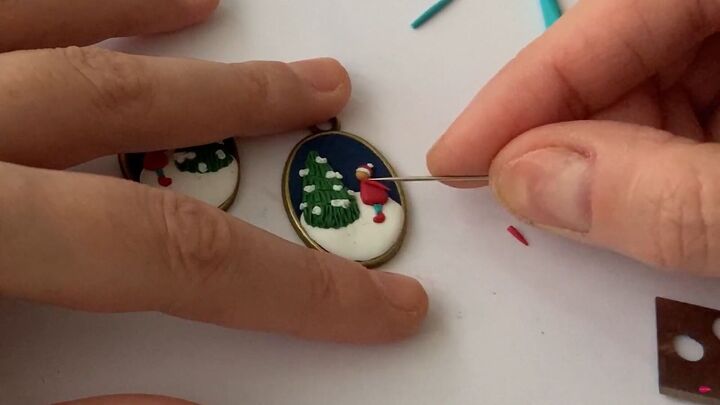 how to make charming diy christmas earrings out of polymer clay, Applying red arms to the person