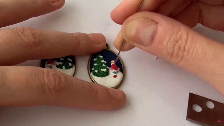how to make charming diy christmas earrings out of polymer clay, Applying white trim to the person s outfit