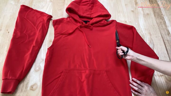 how to make a cute diy christmas dress out of an old red hoodie, Cutting off the hoodie sleeves