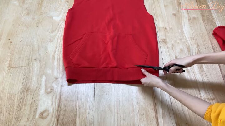 how to make a cute diy christmas dress out of an old red hoodie, Cutting off the ribbing at the bottom