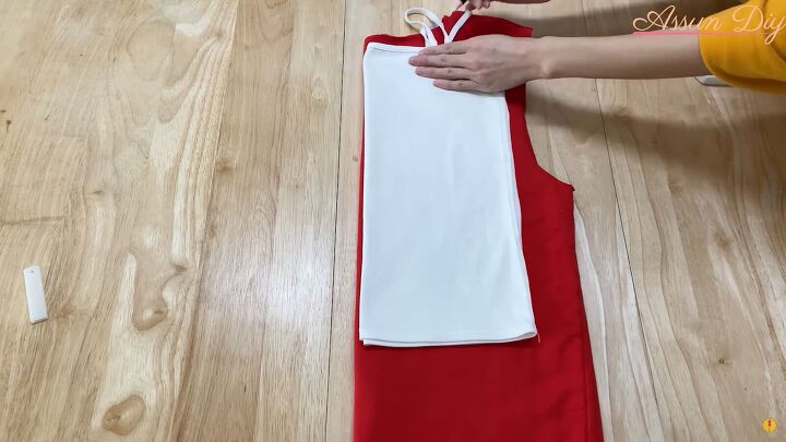 how to make a cute diy christmas dress out of an old red hoodie, Using a strappy top to trace the pattern