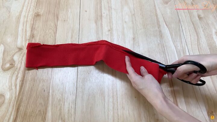 how to make a cute diy christmas dress out of an old red hoodie, Trimming the edges of the ribbing