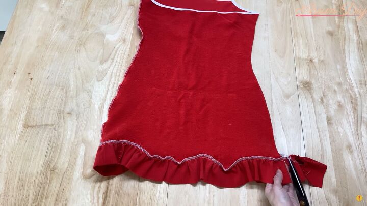 how to make a cute diy christmas dress out of an old red hoodie, Trimming the excess ruffle from the dress