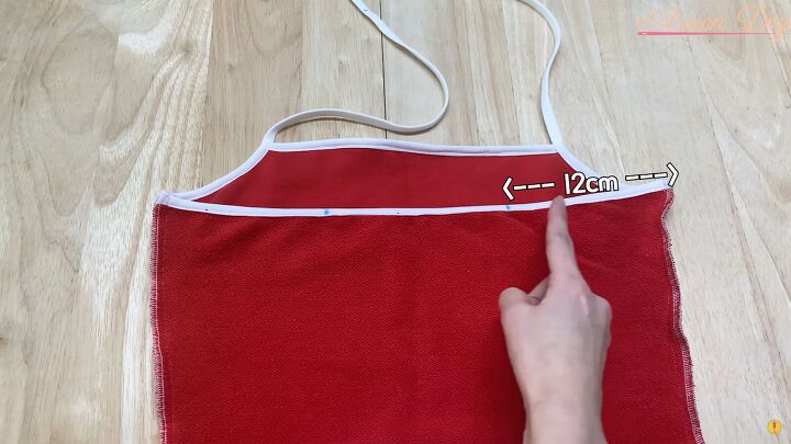 how to make a cute diy christmas dress out of an old red hoodie, Measuring the strap placement