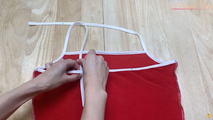 how to make a cute diy christmas dress out of an old red hoodie, Pinning the elastic straps to the dress back