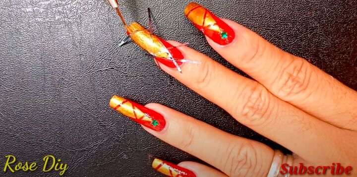 how to paint christmas trees on your nails the easiest way, Painting gold nail polish over the tape