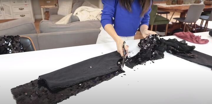 how to make a cute sparkly diy sequin jacket for the holidays, Cutting the sleeves out of sequin fabric