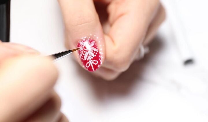 how to easily do festive white red green christmas nail designs, Touching up designs with a thin brush