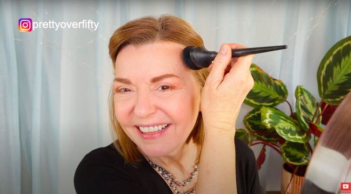 how to do a festive glam holiday makeup look over 50, Applying bronzer to the face