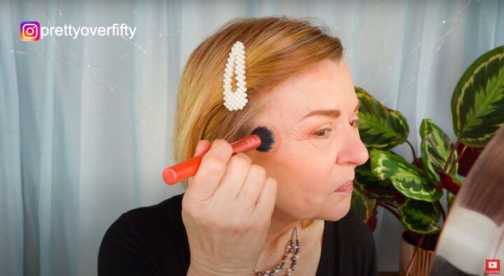 how to do a festive glam holiday makeup look over 50, Applying blush to the cheeks