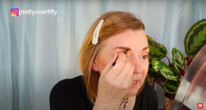 how to do a festive glam holiday makeup look over 50, Filling in eyebrows with a brow pencil