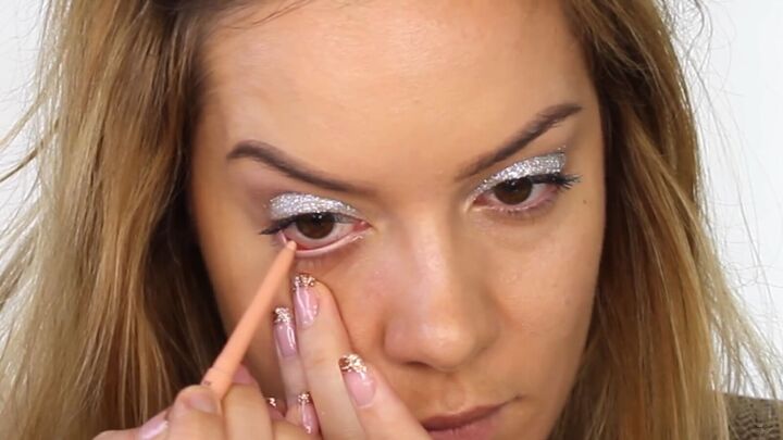 how to do dazzling silver eye makeup for new year s eve, Lining the waterline with a cream eyeliner