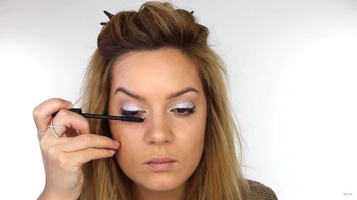 how to do dazzling silver eye makeup for new year s eve, Applying mascara to eyelashes